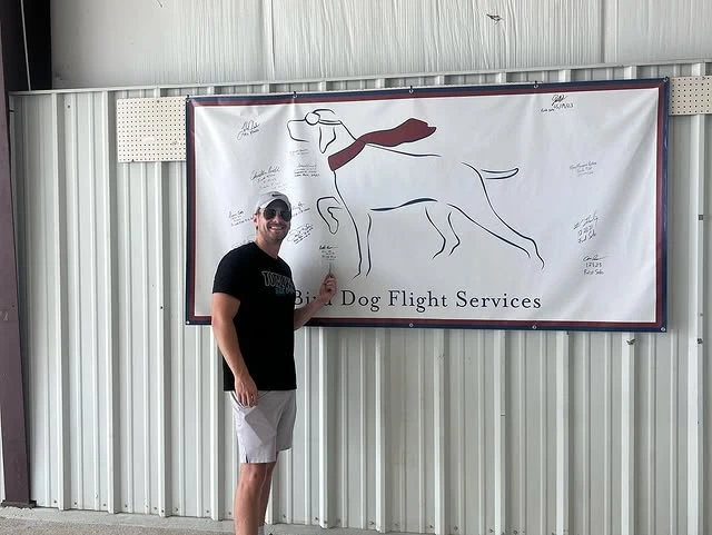 Student signing the solo wall after checkride at Bird Dog Flight Services